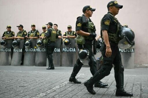 Peruvian police officers stand guard before the election of a new interim president