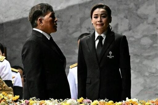 Thailand's King Maha Vajiralongkorn and Queen Suthida stand for the royal anthem at the opening ceremony of the 33rd Southeast Asian Games in Bangkok