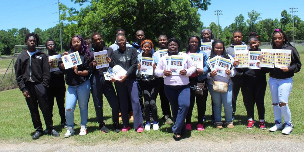 Class giving out papers outside.JPG