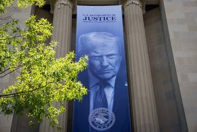 A banner featuring President Trump on the outside of the DOJ building in Washington, D.C.