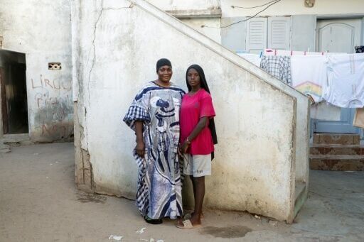 Marieme Wade and her daughter Seynabou Tall are seen in their family home in the small village of Xataxely inside Dakar's Ngor neighbourhood