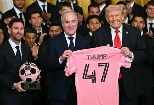 Inter Miami's Argentine superstar Lionel Messi (L), owner Jorge Mas and US President Donald Trump pose with a jersey and a signed ball during a White House event honoring the squad
