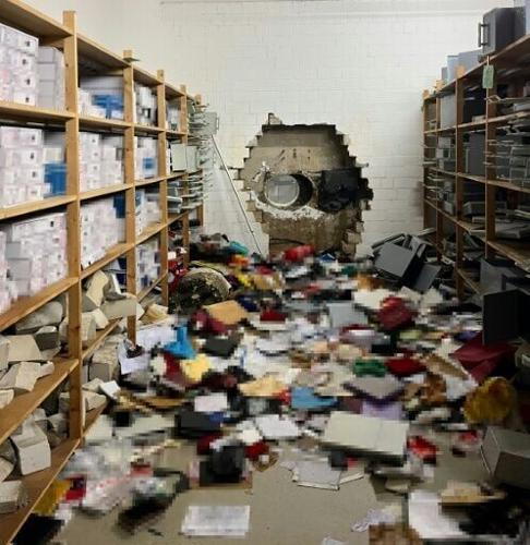 A giant hole in the wall of the bank vault, shown in a photo released by German police