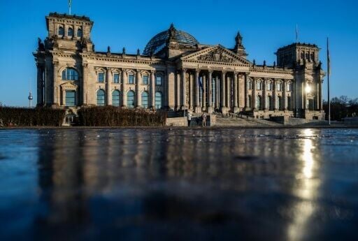 Berlin's Reichstag building, which houses the lower house of parliament, is reflected in a sheet of ice