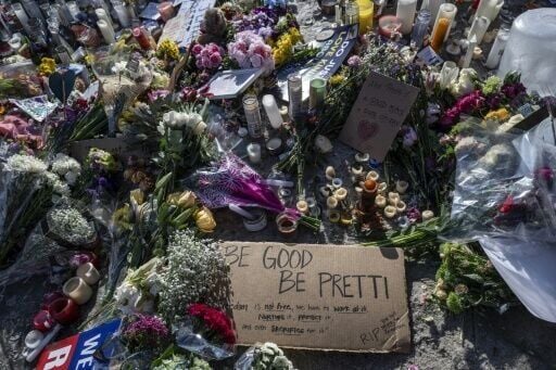 Flowers, signs and momentos are left at a makeshift memorial in the area where Alex Pretti was shot dead by federal immigration agents in Minneapolis