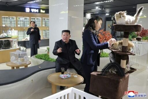 This undated picture released by North Korea's official Korean Central News Agency (KCNA) shows North Korean leader Kim Jong Un (C) and his daughter Kim Ju Ae (R) inspecting a pet shop awaiting the opening of the fourth-stage district of the Hwasong Are...