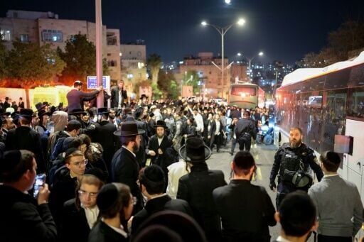 People and police officers gather around a bus following a deadly collision after the bus was surrounded by protesters in January