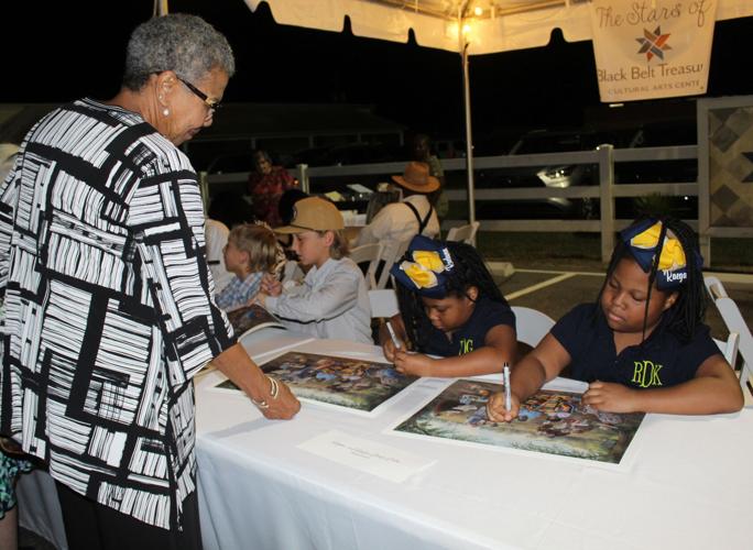 Girls signing print at Black Belt Treasures
