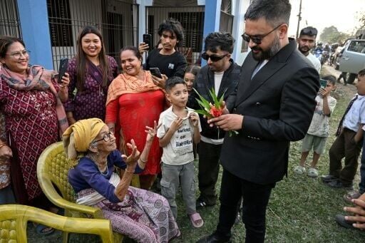 Balendra Shah (R), Rastriya Swatantra Party (RSP) election candidate and Kathmandu's former mayor greets supporters during a door-to-door election campaign at Gauriganj in Jhapa district on February 16, 2026