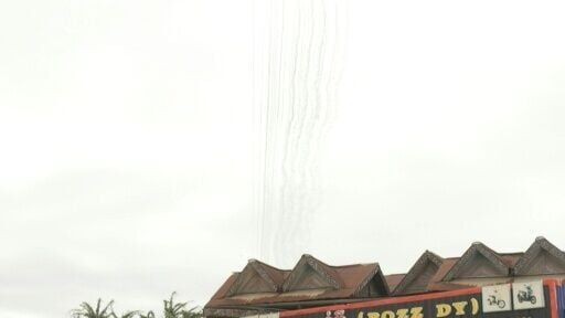 Trails of smoke are visible in the sky above the Cambodian border town of Samraong, as the Cambodian military fires artillery towards Thailand
