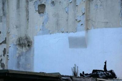 Banksy's latest work shows 2 people lying on the ground and pointing at the sky
