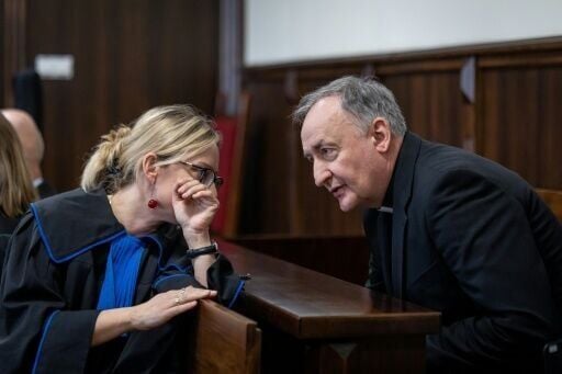 Bishop Andrzej Jez confers with his lawyer in court