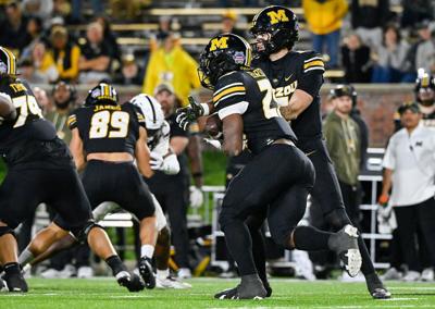 Mizzou quarterback Matt Zollers (5) hands the ball off to Mizzou running (copy)