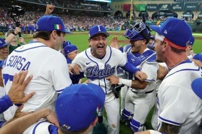 Italy manager Francisco Cervelli (center) celebrates with his players after their 8-6 victory over Puerto Rico saw them advance to the World Baseball Classic semi-finals