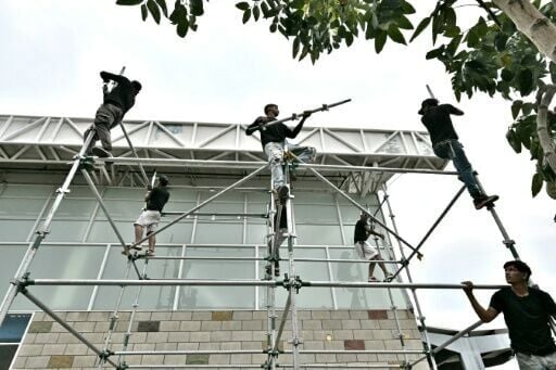 Staff members dismantle a stage after the cancellation of Venezuela's interim President Delcy Rodriguez's visit at the Atanasio Girardot International Bridge on the outskirts of Cucuta, Colombia on March 12, 2026. The first foreign visit of Venezuela's ...
