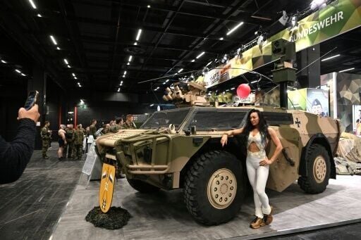 A parked Fennek armoured reconnaissance vehicle served as an attention-grabbing advertisement for the Bundeswehr's recruiting stand -- and a photo backdrop for visitors