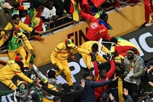 Senegal supporters clash with security forces after a penalty was awarded against their team