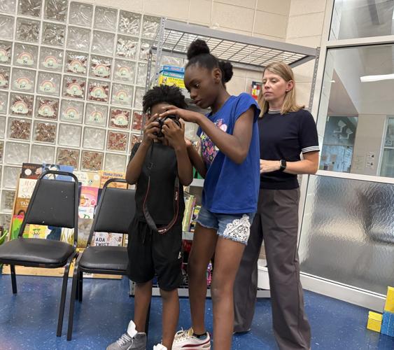 Cindy working with camera and students