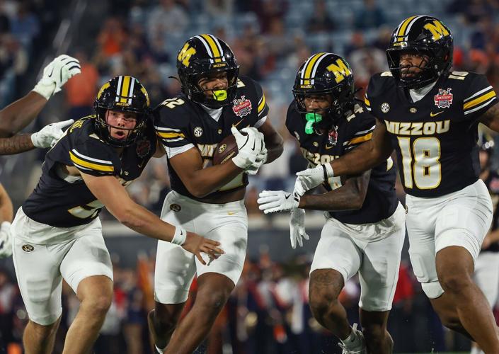 Missouri long snapper Brett Le Blanc (51) protects running back Tavorus Jones (22)