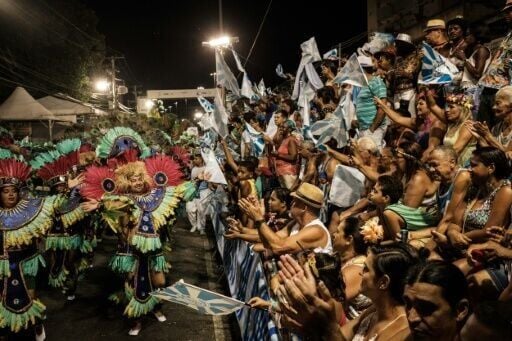 The crowd goes wild for third-division samba school Caprichosos de Pilares during their parade on Intendente Magalhaes street in 2017