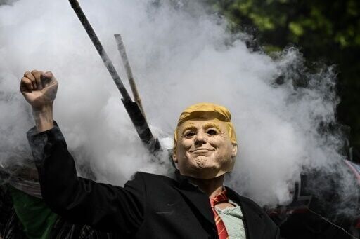 Waves of protesters flood US streets against 'king' Trump