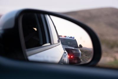 Police traffic stop in rear view mirror from Alabama Reflector