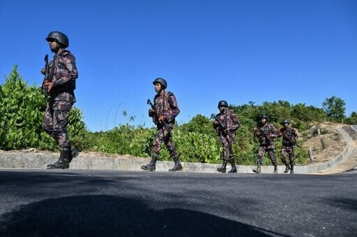 Border Guard Bangladesh (BGB) personnel patrol near the Bangladesh-Myanmar frontier in Bandarban district