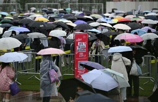 BTS fans stand in lines at a fan zone ahead of a concert by K-pop boy band BTS at a stadium in Goyang on April 9, 2026.