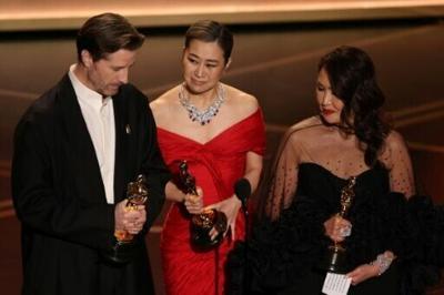 Co-director Maggie Kang (C) dedicated the film's Oscars triumph to "Korea and Koreans everywhere"