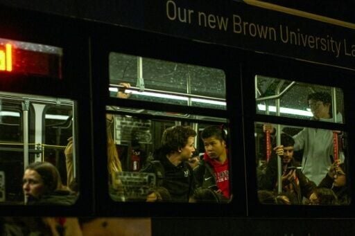 Brown University students are evacuated in a public bus after a mass shooting on campus