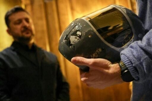 Ukrainian skeleton racer Vladyslav Heraskevych presents to Ukrainian President Volodymyr Zelensky the helmet that led to his disqualification from the 2026 Winter Olympics