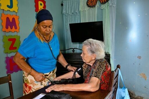 A Cuban doctor provides medical care to an elderly woman at the Nazareth Baptist Church in Havana severe economic crisis