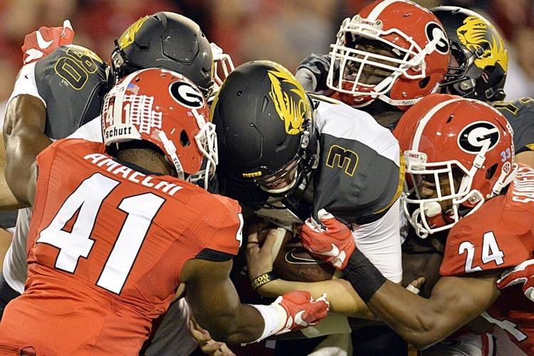 Drew Lock is tackled as he runs the ball (copy)