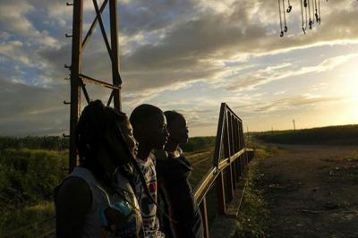 Young people of Haitian descent hang out in the Batey La Lima community, surrounded by a massive sugarcane plantation in the coastal city of La Romana, Dominican Republic.