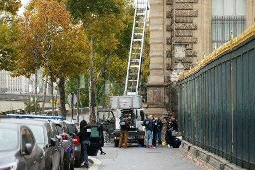 French police officers inspect a furniture elevator used by the thieves