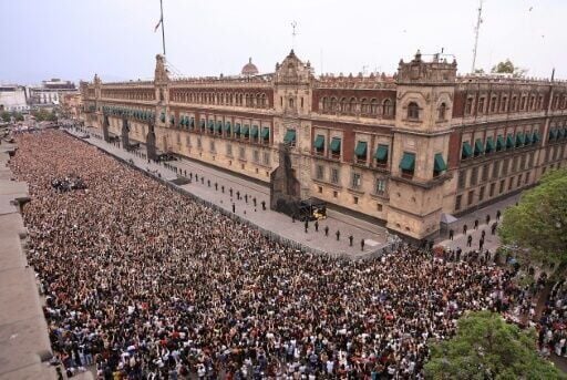 In this handout picture released by Mexico's presidencial press office, some 50,000 fans of South Korea's K-pop band BTS came to see the band at the Palacio Nacional in Mexico City