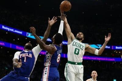 Jayson Tatum (R) of the Boston Celtics led the charge, racking up 21 points in the first half