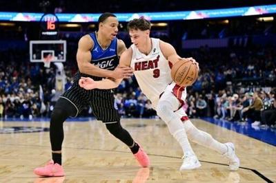 Orlando's Desmond Bane, at left guarding Miami's Pelle Larsson, scored 37 points to lead the Magic over the Heat 117-108 and into the NBA Cup semi-finals