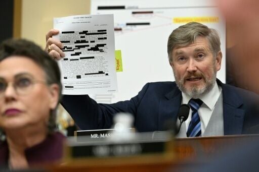 US Representative Thomas Massie, a Republican from Kentucky, holds up redacted documents from the Epstein files during an oversight hearing with Attorney General Pam Bondi