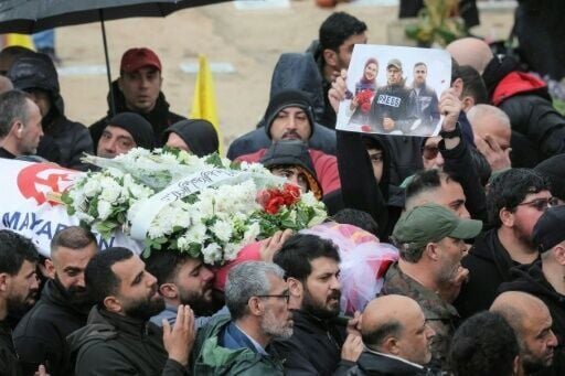 Mourners carry the body of one of the three journalists killed in southern Lebanon