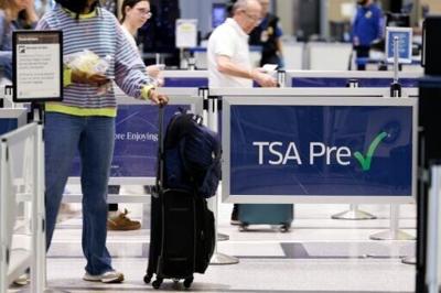 People wait in line at a TSA security checkpoint at William P. Hobby Airport in Houston, Texas on March 10, 2026