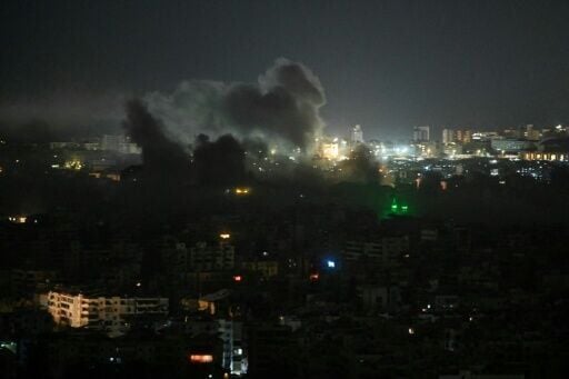 A plume of smoke rises from the site of an Israeli airstrike in the southern suburbs of Beirut early on March 12