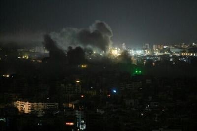 A plume of smoke rises from the site of an Israeli airstrike in the southern suburbs of Beirut early on March 12