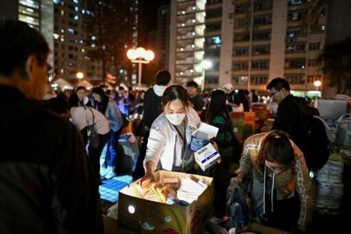 Crowds gathered to distribute daily necessities after the major fire that swept through several apartment blocks at the Wang Fuk Court residential estate in Hong Kong's Tai Po district