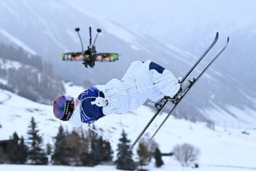 A drone hovers as UK's Makayla Gerken Schofield competes in the freestyle skiing women's moguls during the Milano Cortina 2026 Winter Olympic Games at Livigno Aerials & Moguls Park