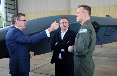 Australian Minister for Defence Industry Pat Conroy, Germany's Defence Minister Boris Pistorius and Royal Australian Air Force Chief Stephen Chappell speak next to a Ghost Bat drone during a visit to the Amberley RAAF Base on March 27, 2026.