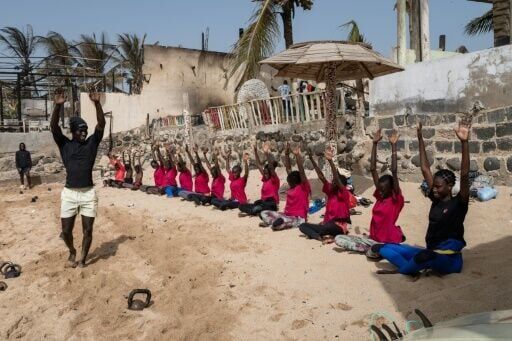 Surf Academy girls participate in exercise and meditation before hitting the waves