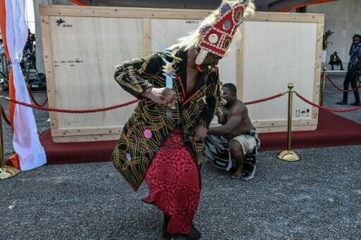 A crate holding the Djidji Ayokwe, or 'talking drum', looted by French colonial troops from Ivory Coast in 1916, arrived home in Abidjan