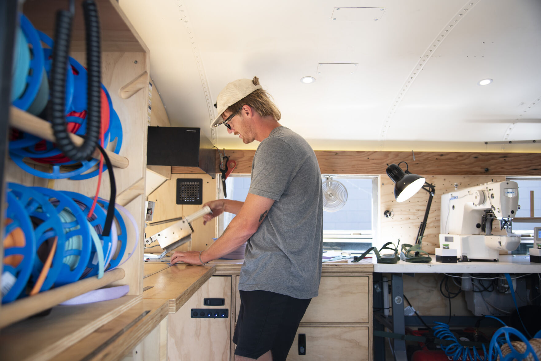 Chaco roving repairs bus stops in Bozeman during summer long tour