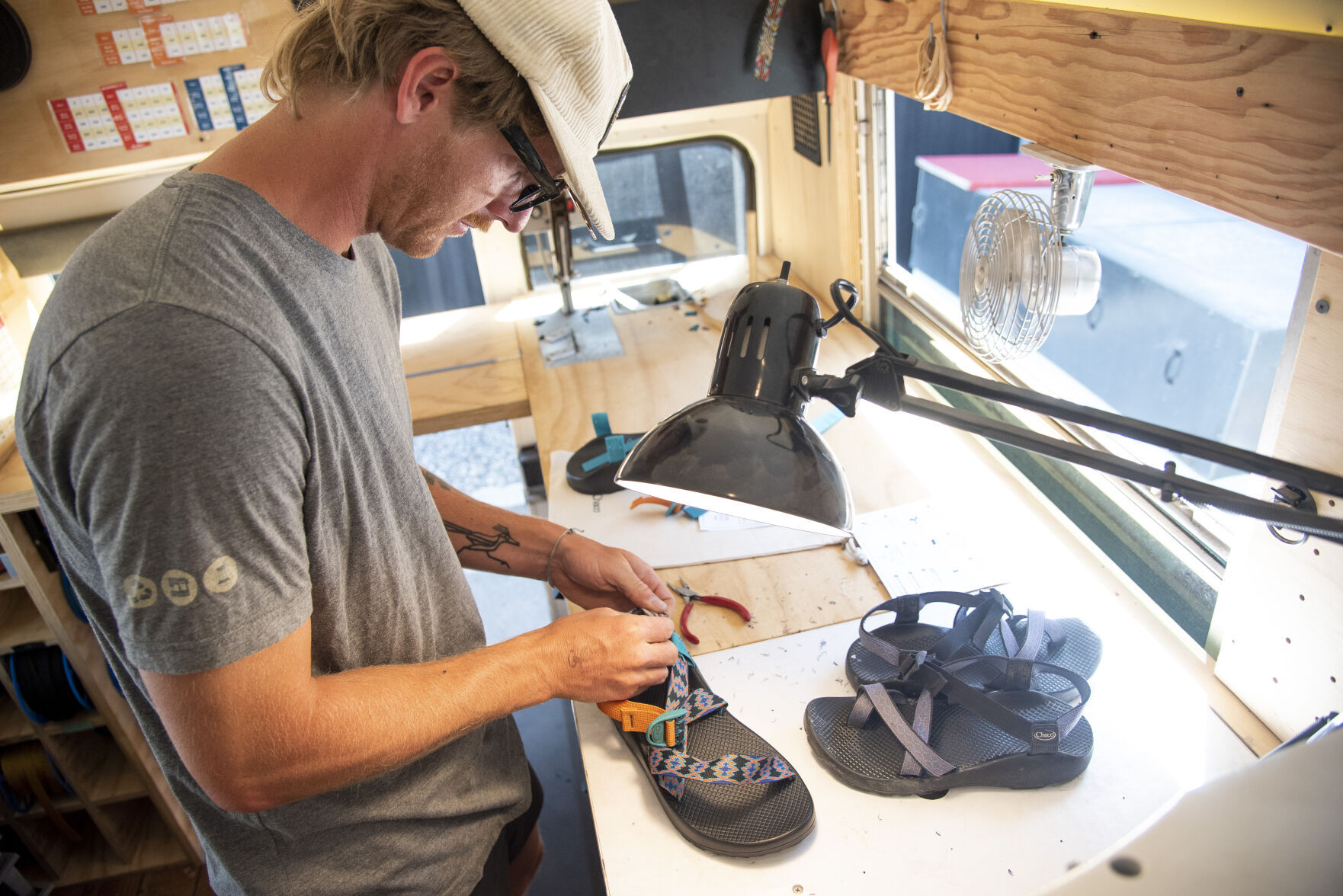 Chaco roving repairs bus stops in Bozeman during summer long tour